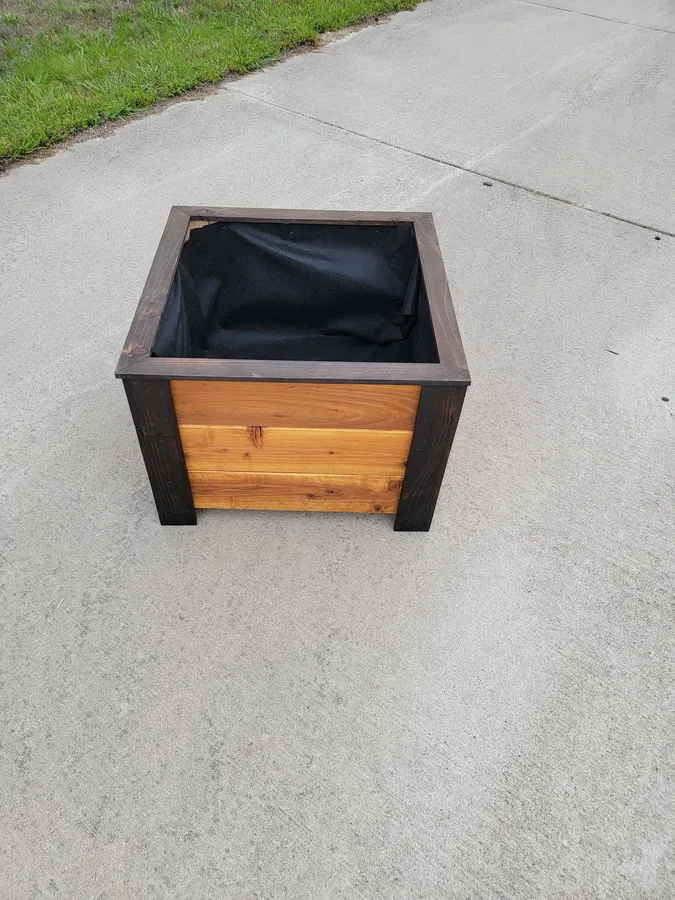 Outdoor wooden display piece with black trim detailing